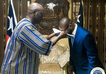 Amb Pattern kisses the Bible affirming the oath of office as Liberia's Ambassador to the United StatesEXECUTIVE MANSION
