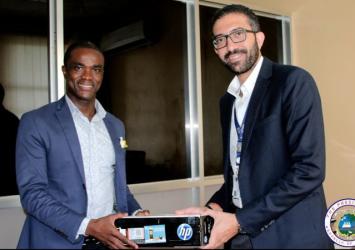 IOM Office in Charge Amr Nagy presents supplies to Min Trokon Kpui.EXECUTIVE MANSION