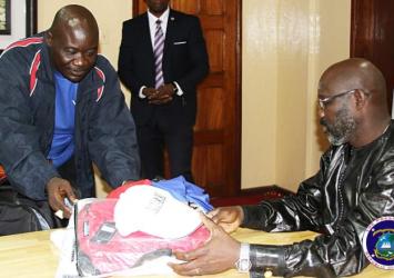 LNOC Officer presents uniforms to President WeahEXECUTIVE MANSION