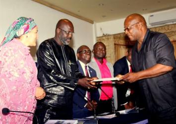 Presentation of the Conference Resolution to Pres Weah by Peace Amb Rev William R Tolbert III as UN DEP SG looks onExecutive Mansion Photo