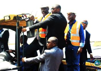 President Weah and Public Works Minister ride Tractor to start the construction of road connecting Doe Community to Clara Town.EXECUTIVE MANSION