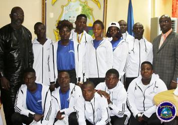 President Weah and Youth & Sports Minister Wilson pose with AthletesEXECUTIVE MANSION