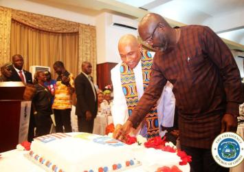 President Weah cutting LIBA Anniversary Cake as the business group newly inducted leader looks onEXECUTIVE MASNION