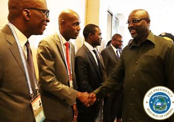 President Weah greets Information Minister Eugene Nagbe upon arrival in China for FOCAC 2018EXECUTIVE MANSION