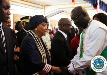 President Weah greets former President Sirleaf at the Independence Day ceremonyEXECUTIVE MANSION