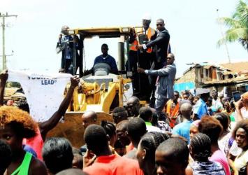 President Weah rides Tractor as he instructs the commencement of Doe Community Road Construction.EXECUTIVE MANSION