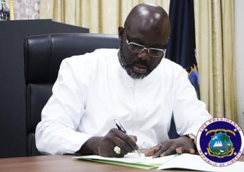 President Weah signing the deedEXECUTIVE MANSION