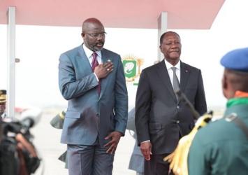 President Weah stands shoulder-to-shoulder with Ivorian Counterpart stand in honor of the National anthems of both countriesExecutive Mansion Photo