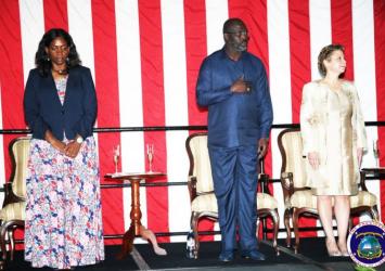 President and Madam Weah along with US Ambassador  honor national anthem at the US 242nd Independence Ceremony in Monrovia EXECUTIVE MANSION