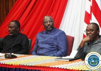 President weah seated with Min McGill and River-gee Senator Comany Wesseh at the Commissioning CeremonyExecutive Mansion